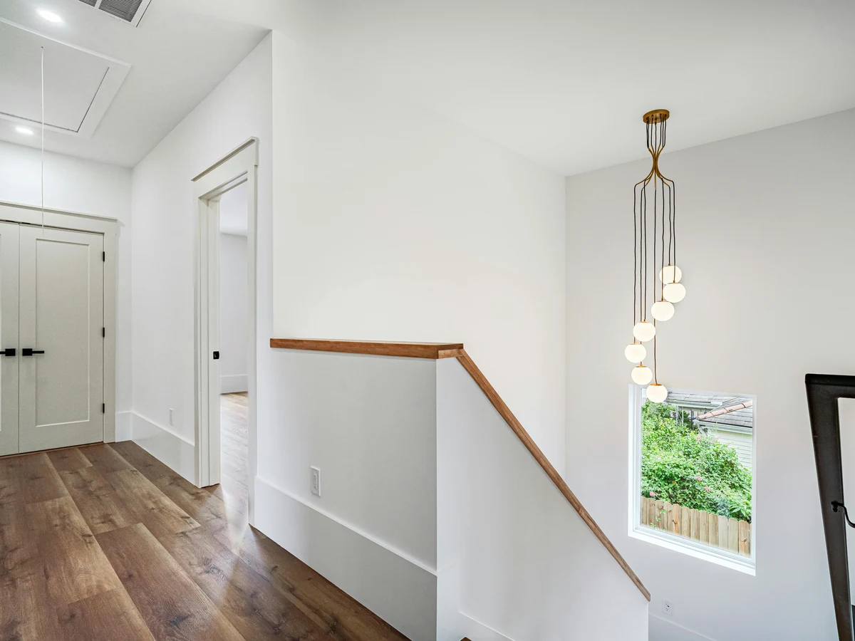Modern white staircase landing painted by Darlington Decorators in Darlington